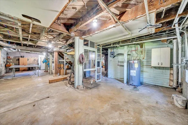 a view of a porch with chairs and potted plants