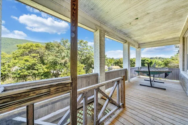 a front view of a house with a yard and shrubs
