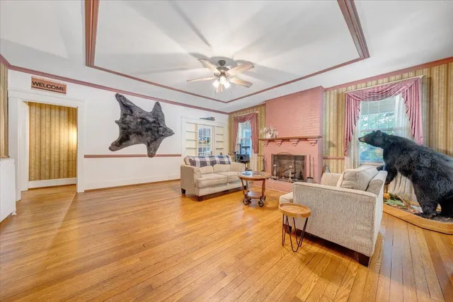 a kitchen with stainless steel appliances a sink cabinets and a wooden floor