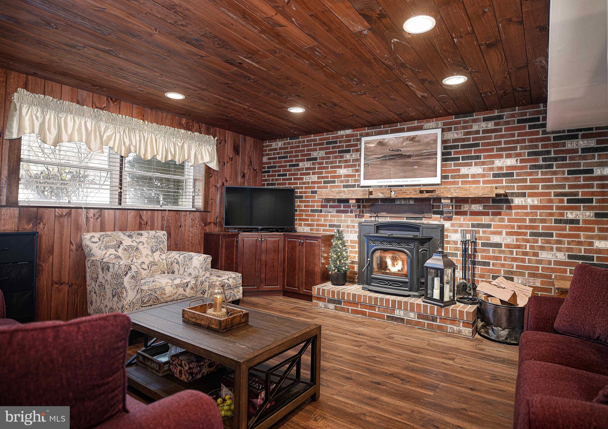 3204 Hunt Road Fallston, MD 21047 - Photo 26 of 54 a living room with furniture a flat screen tv and a fireplace
