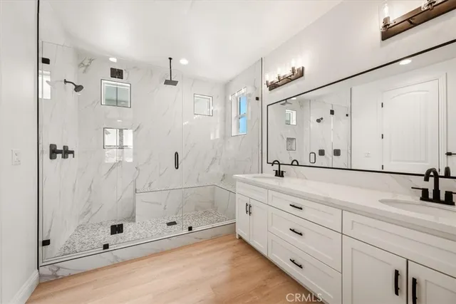 a bathroom with a shower sink and mirror
