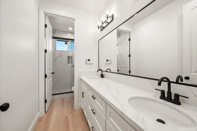 a bathroom with a double vanity sink and mirror