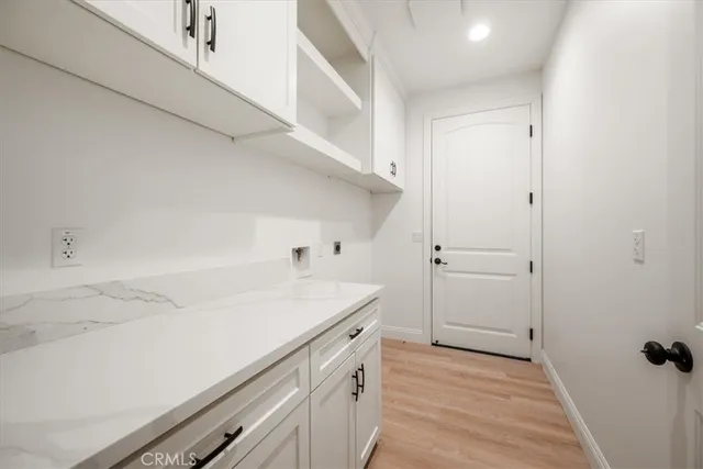 a view of a kitchen with white cabinets