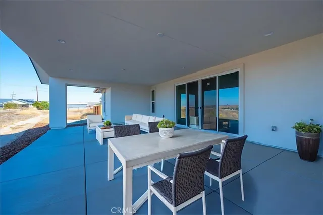 a view of a dining room with furniture and window