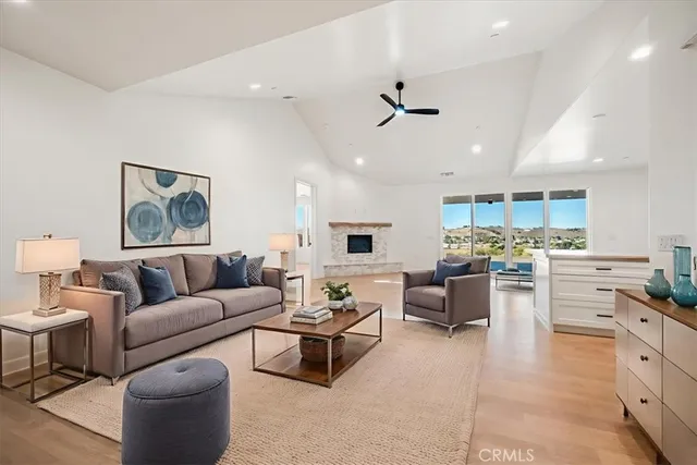 a living room with furniture and kitchen view