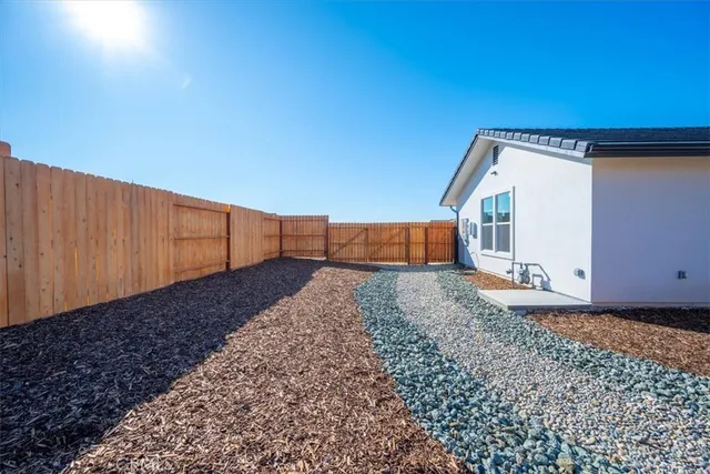 a backyard of a house with wooden fence