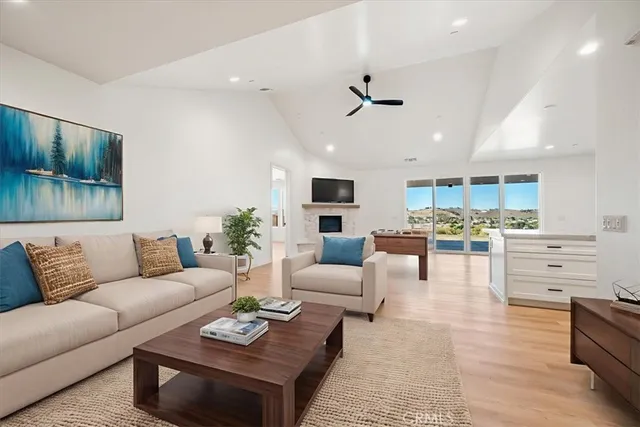 a living room with furniture kitchen view and a window