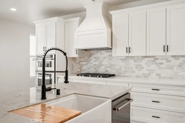 a kitchen with a sink a window and cabinets