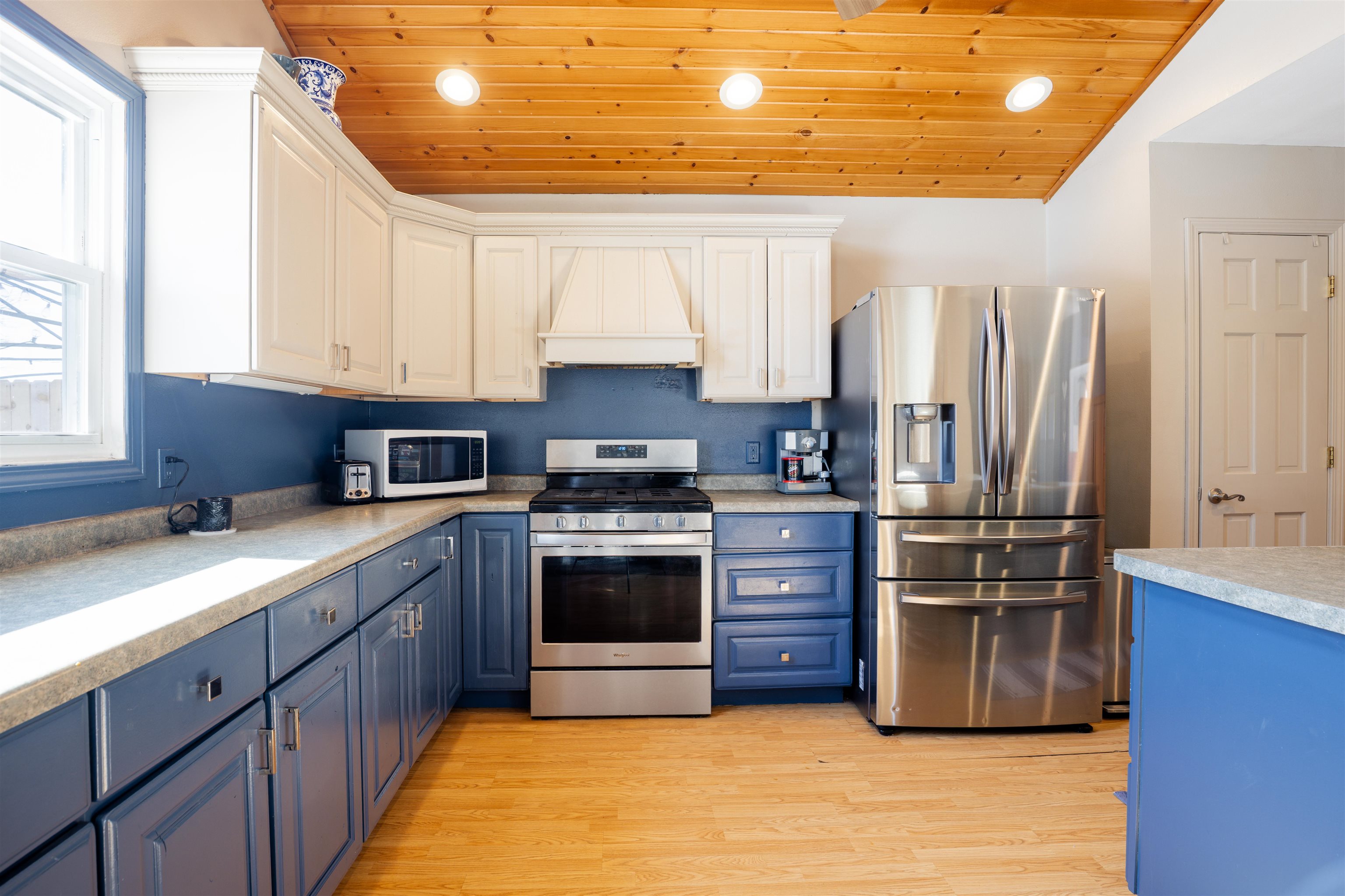 a kitchen with stainless steel appliances granite countertop a stove a sink and a refrigerator