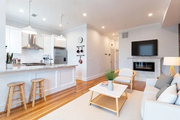 a living room with fireplace furniture and a flat screen tv