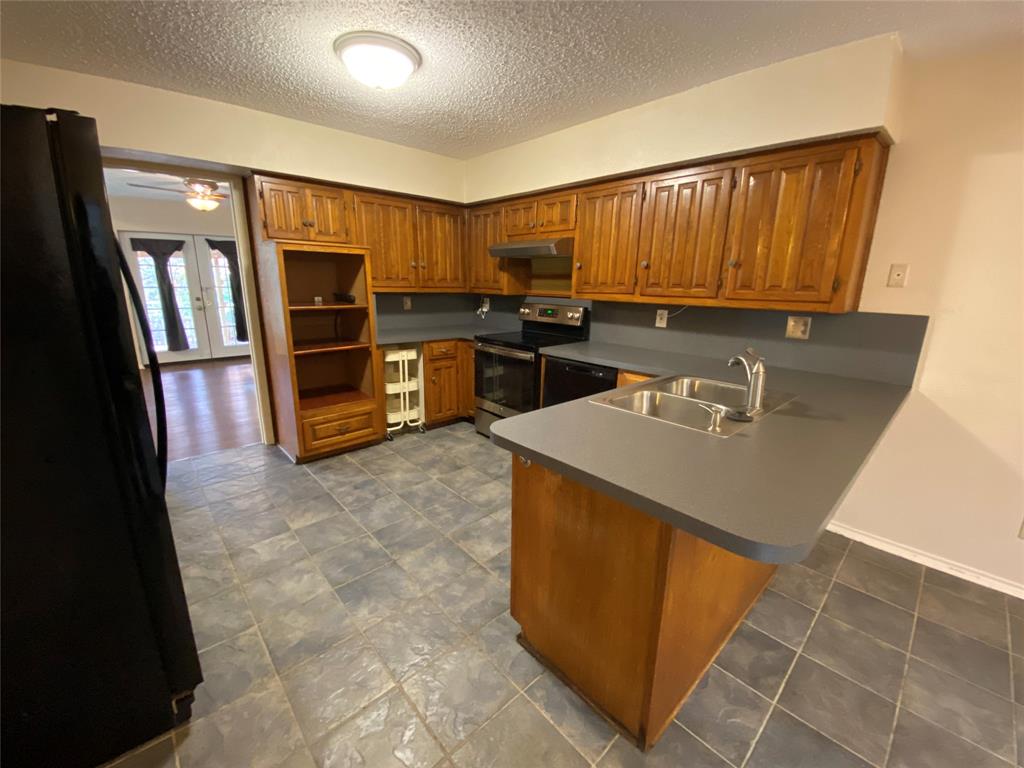 606 Old Country Road Duncanville, TX 75137 - Photo 11 of 22 a kitchen with sink refrigerator and microwave