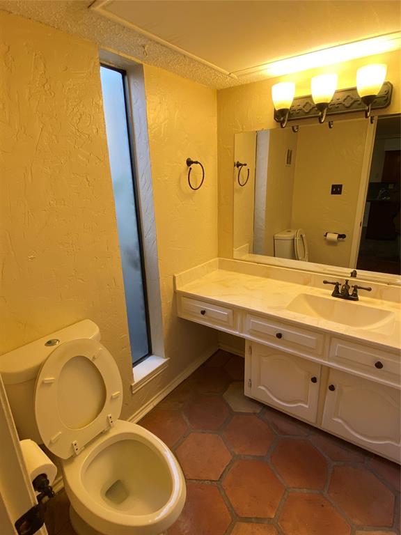 606 Old Country Road Duncanville, TX 75137 - Photo 12 of 22 a bathroom with a sink mirror vanity and toilet