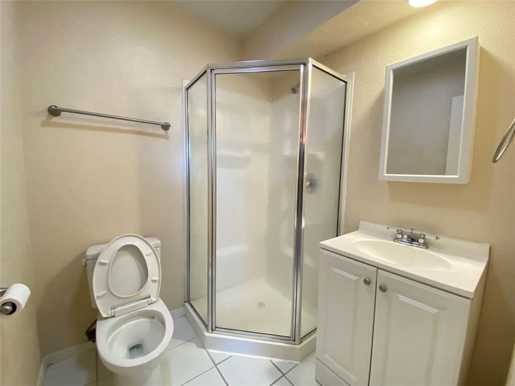 606 Old Country Road Duncanville, TX 75137 - Photo 15 of 22 a bathroom with a granite countertop sink toilet and shower