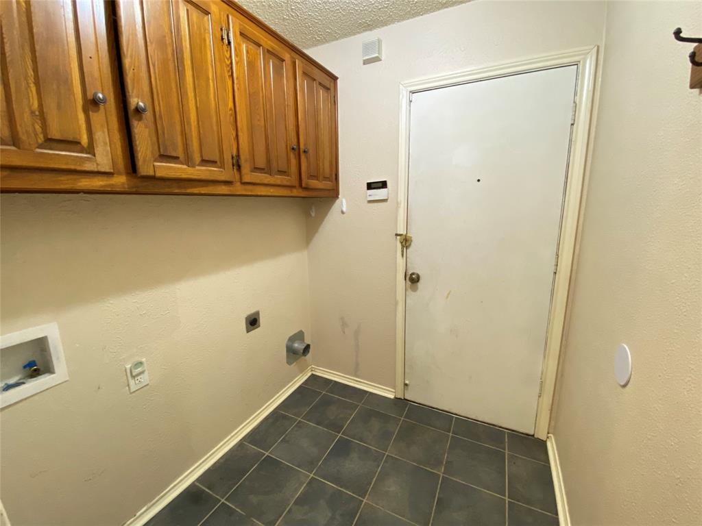 606 Old Country Road Duncanville, TX 75137 - Photo 19 of 22 a view of a storage & utility room with racks