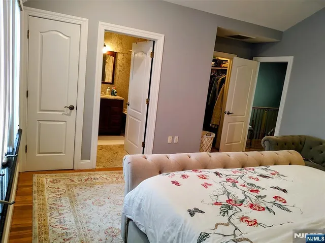 a bedroom with a bed and a dresser