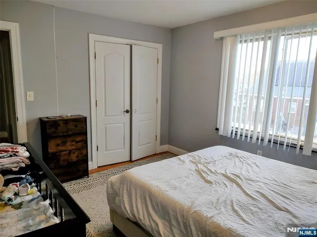 a bedroom with a bed and a closet