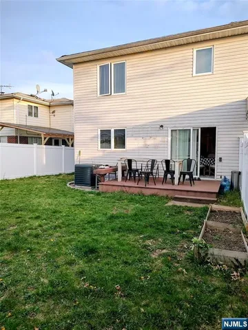 a group of people sitting in front of a house