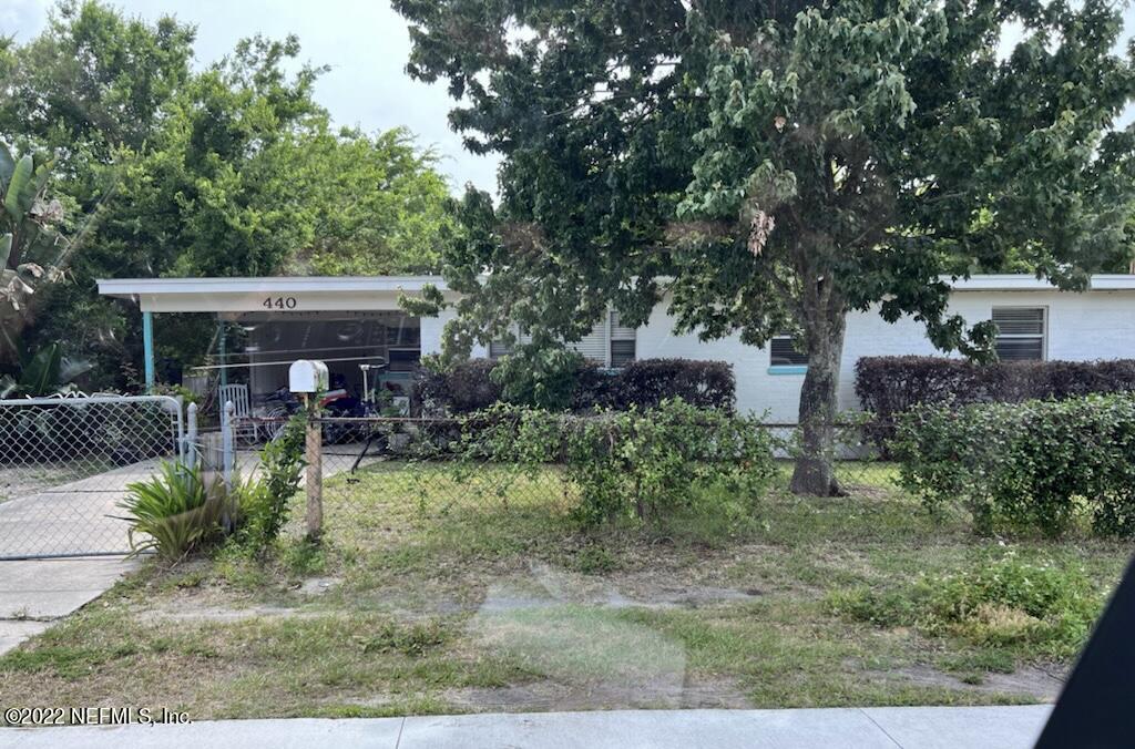 440 Skate Road Atlantic Beach, FL 32233 - Photo 1 of 1 a view of a patio with table and chairs potted plants and large tree