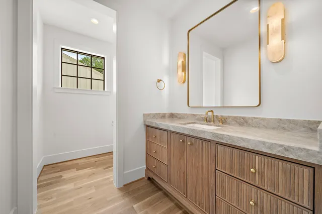 a kitchen with white cabinets and sink