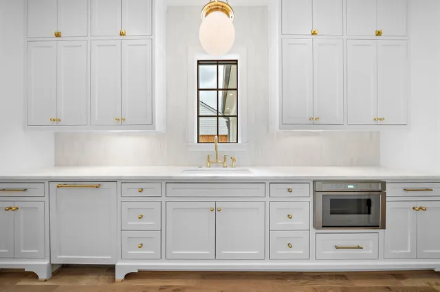 a view of cabinets and utility room with closet