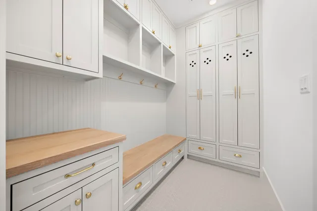 a spacious en suite bathroom with a double vanity sink a mirror and a bathtub