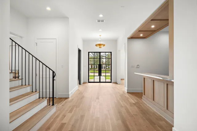 a view of an empty room with a fireplace and a window