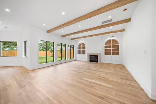 a large kitchen with kitchen island white cabinets and stainless steel appliances