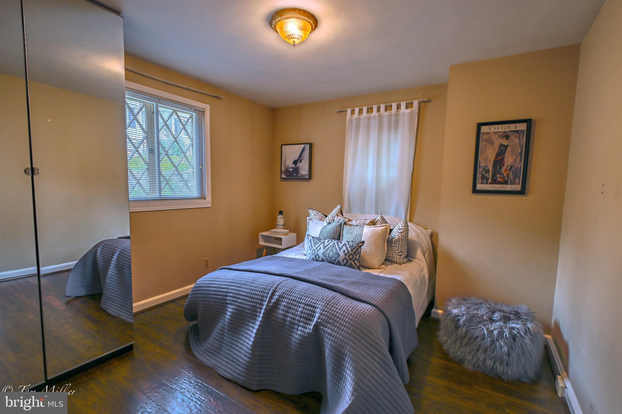 5815 Lochlea Road Baltimore, MD 21209 - Photo 12 of 40 a bedroom with a bed and a painting on the wall