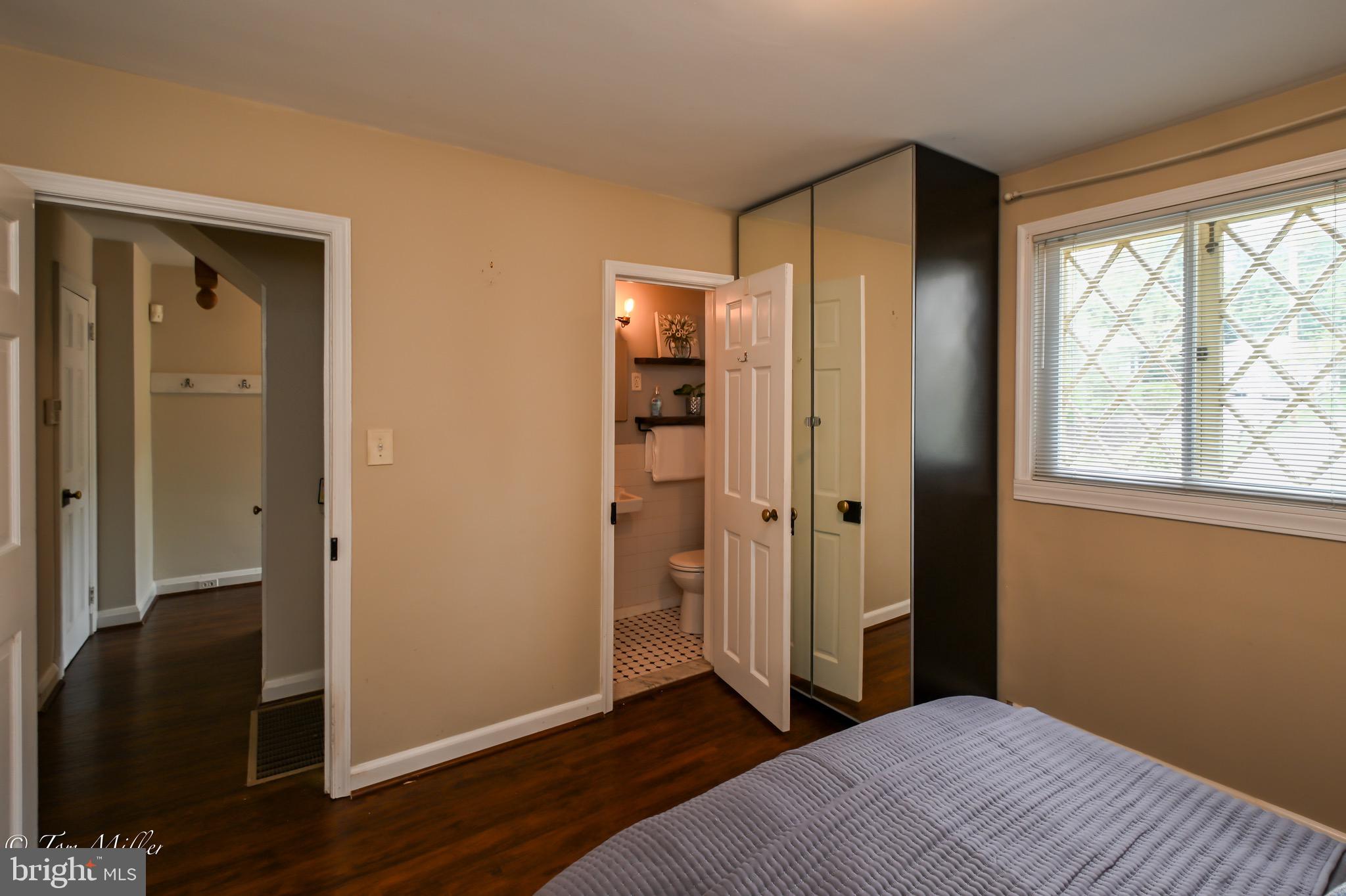 5815 Lochlea Road Baltimore, MD 21209 - Photo 14 of 40 a bedroom with a bed and wooden floor