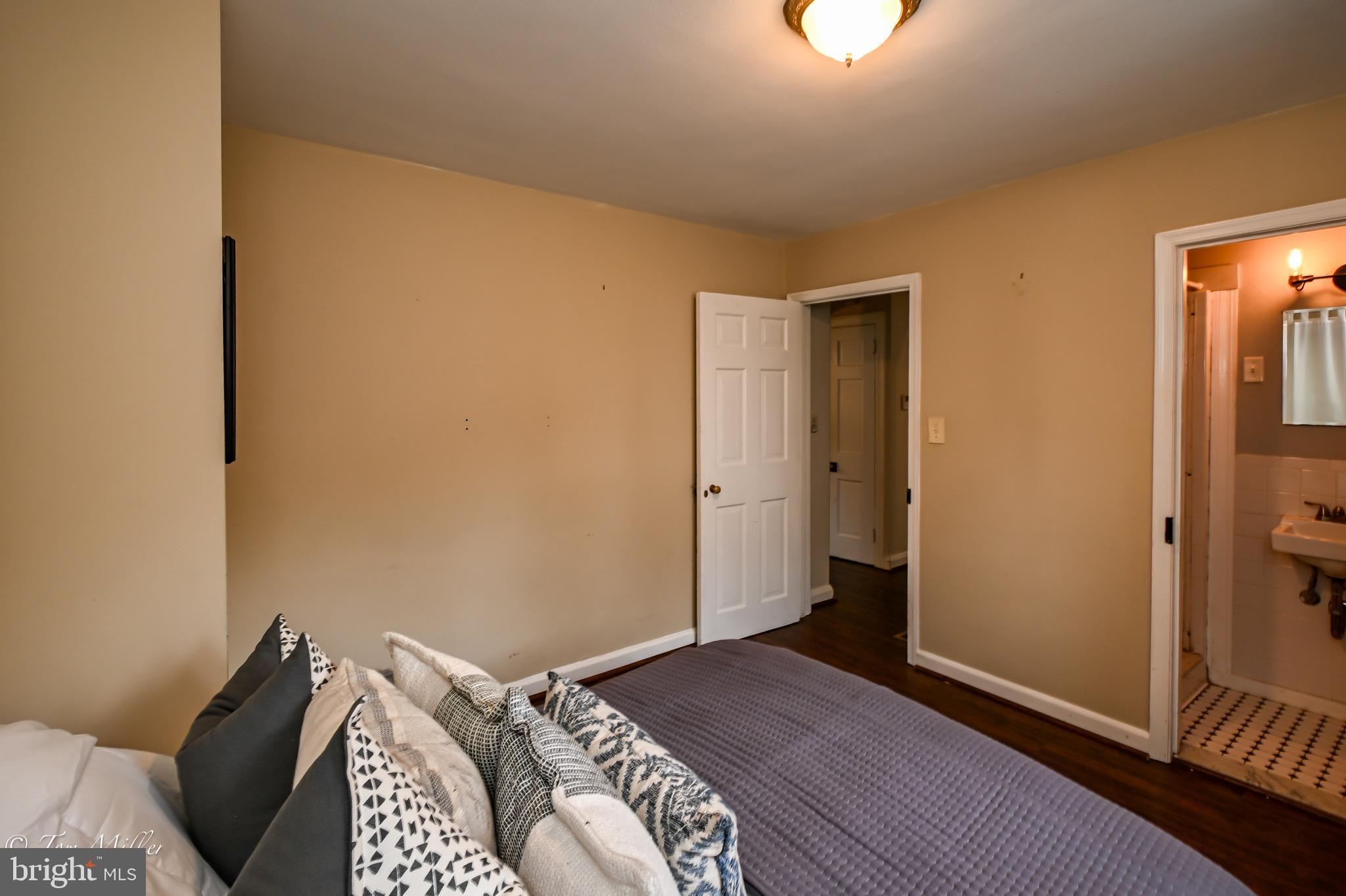 5815 Lochlea Road Baltimore, MD 21209 - Photo 15 of 40 a bedroom with a bed and a window