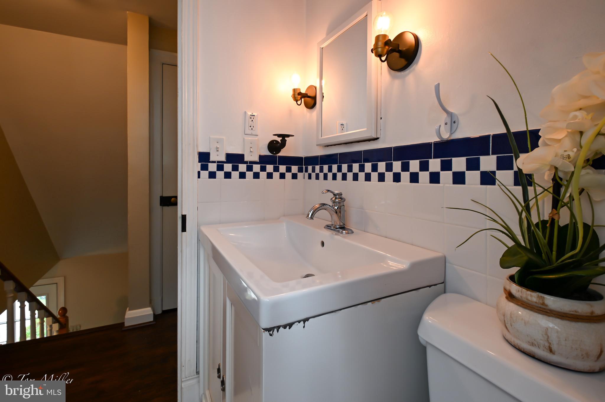 5815 Lochlea Road Baltimore, MD 21209 - Photo 23 of 40 a bathroom with a sink and a mirror