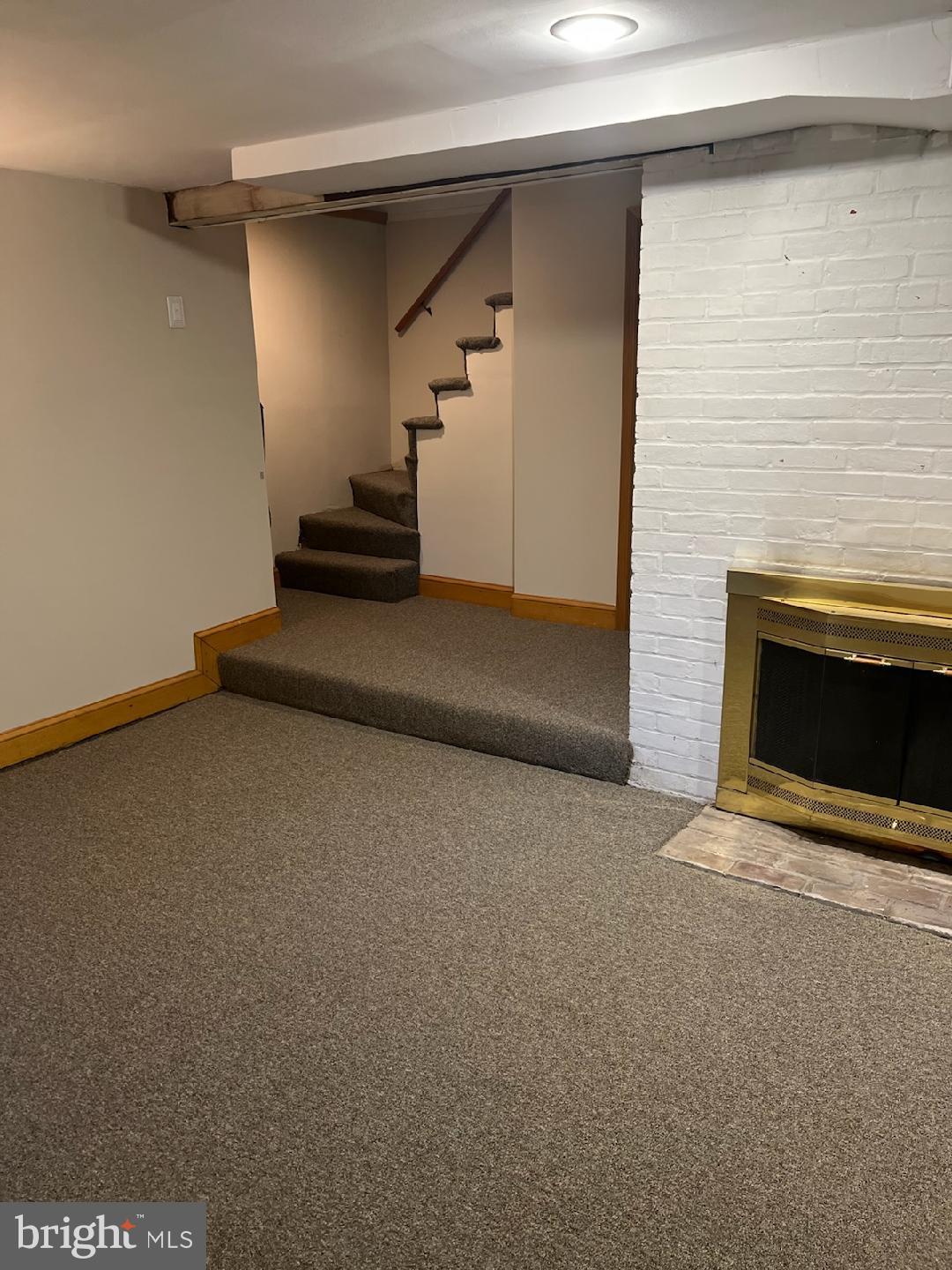 5815 Lochlea Road Baltimore, MD 21209 - Photo 27 of 40 a view of an empty room with wooden floor and a fireplace