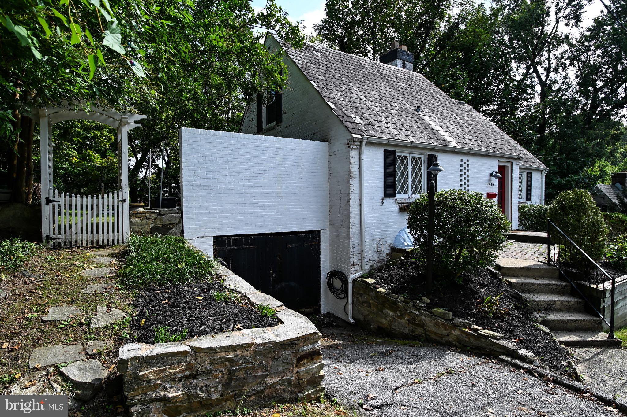 5815 Lochlea Road Baltimore, MD 21209 - Photo 31 of 40 a view of a house with a yard and potted plants
