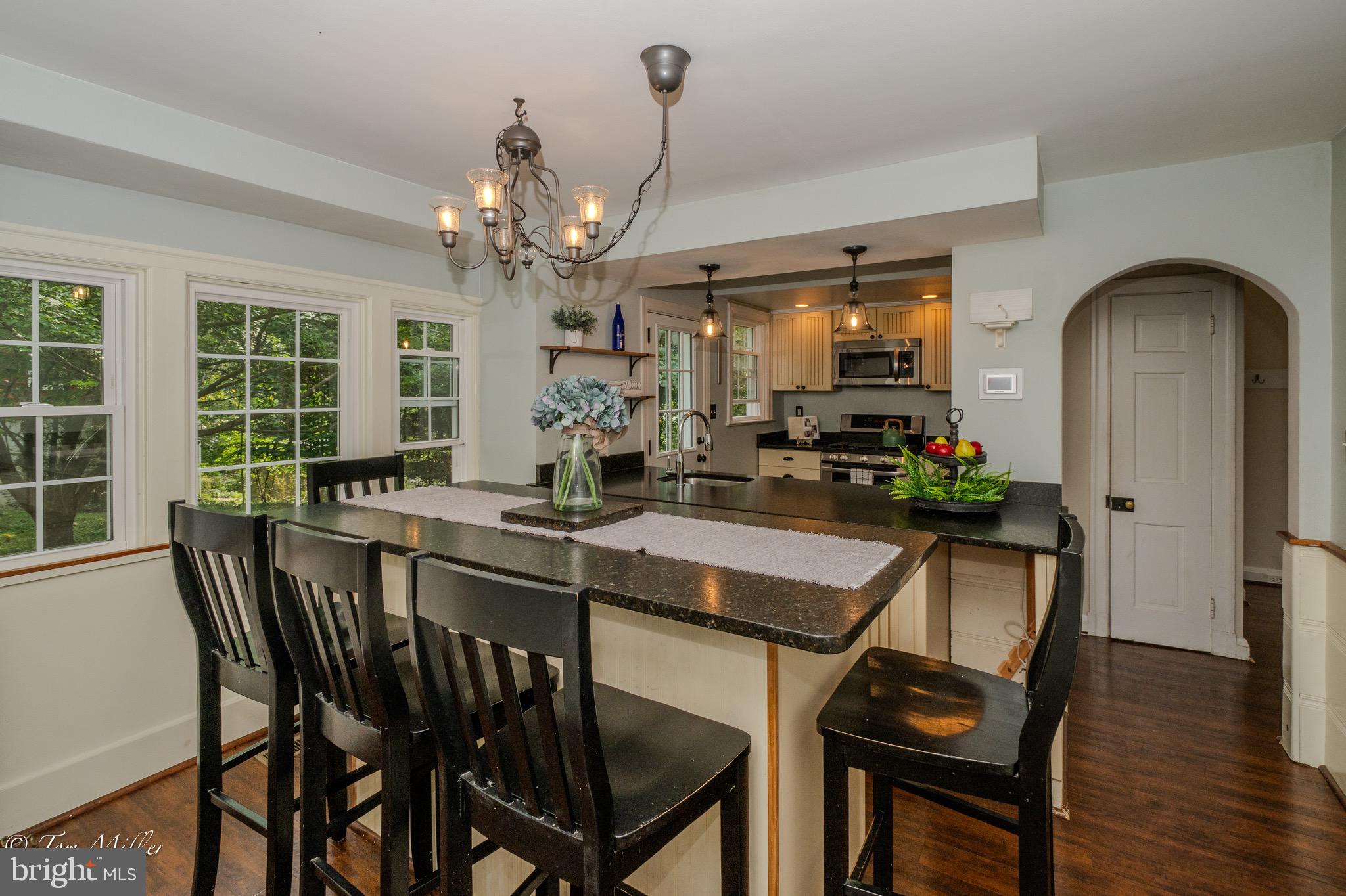5815 Lochlea Road Baltimore, MD 21209 - Photo 10 of 40 a dining room with furniture potted plants and wooden floor