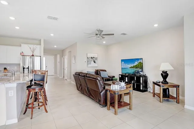 a kitchen with a sink a stove a refrigerator and white cabinets