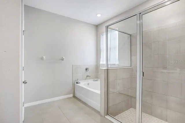 a bedroom with a bed and a lamp