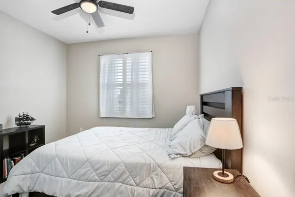 a bedroom with a bed and a window