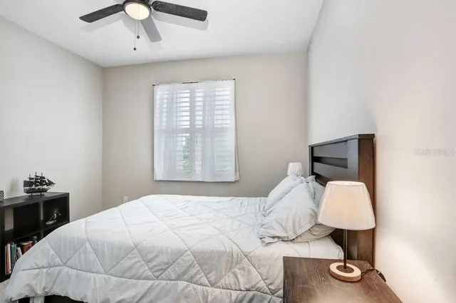 a bedroom with a bed and a window