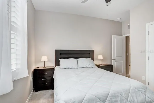 a bedroom with bed and a chandelier