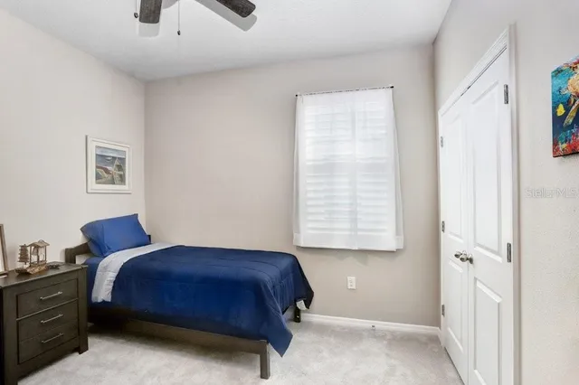 a bathroom with a granite countertop sink a toilet and a shower curtain