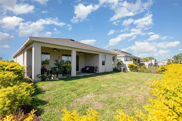 a view of a house with swimming pool and furniture
