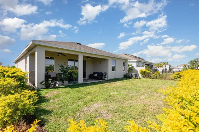 a view of a house with swimming pool and furniture