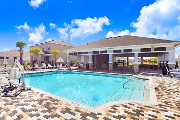 a view of a swimming pool and lounge chair