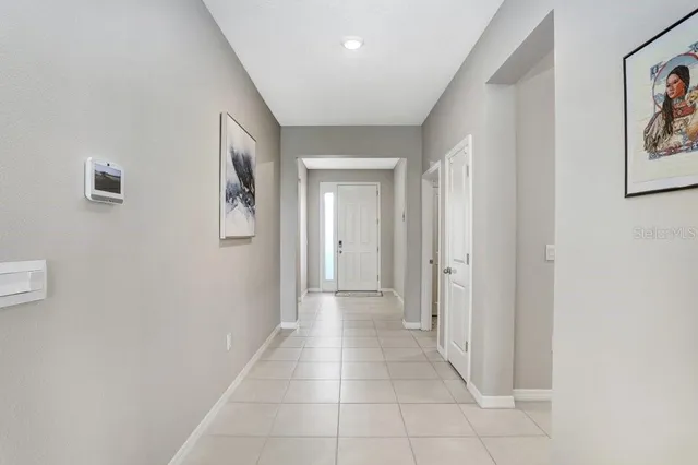 a view of a hallway with dining area and livingroom