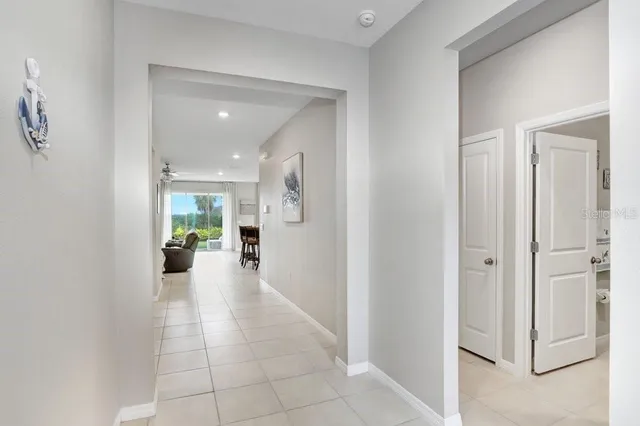 a open kitchen with stainless steel appliances granite countertop a stove top oven a sink a dining table and chairs