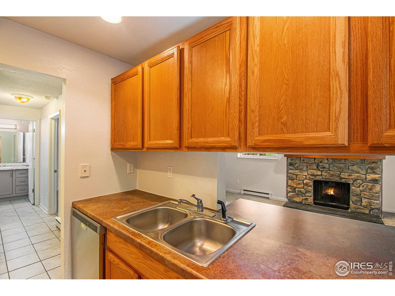 4068 South Atchison Way, Unit 101 Aurora, CO 80014 - Photo 2 of 12 a kitchen that has a sink and a stove in it