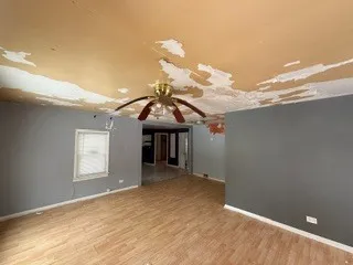 a view of a room with window and hardwood