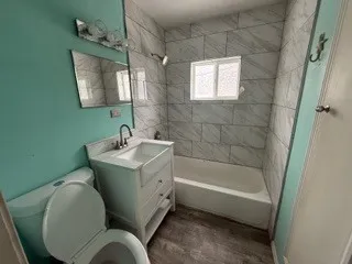 a bathroom with a sink mirror toilet and bathtub