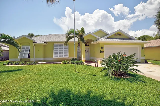 a view of a house with a swimming pool and a yard