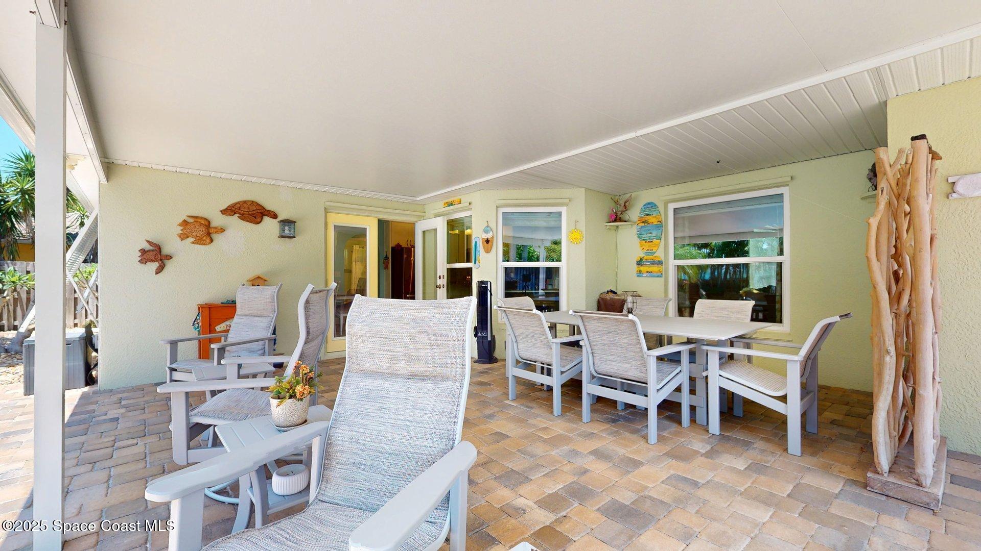 103 Matanzas Road Melbourne Beach, FL 32951 - Photo 11 of 37 a living room with furniture a rug and white walls
